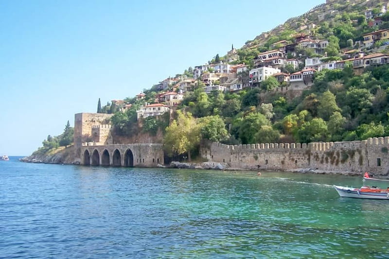 Alanya: Pirate Boat with Transfer, Lunch & Unlimited Drinks - Leaving the harbor with the Red Tower and castle in view
