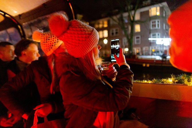 Amsterdam Evening Canal Cruise with Live Guide and Onboard Bar - Drinks, cheese, and the Heineken issue