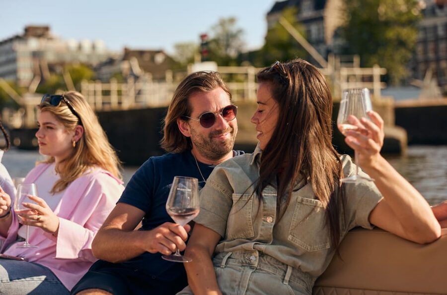 Amsterdam: German Guided Canal Cruise with on Board Bar - Montelbaanstoren, Rembrandt’s home, and canal-side stories