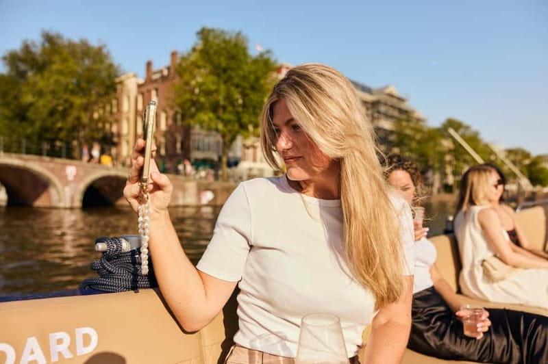 Amsterdam: Spanish Guided Open Boat Cruise with Bar Onboard - The Skinny Bridge and the Amstel Hotel