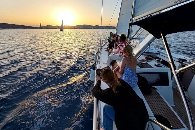 Barcelona Sunset Sailing Cruise from Port Olímpic with Open Bar - Hoisting the sails in front of Barcelona