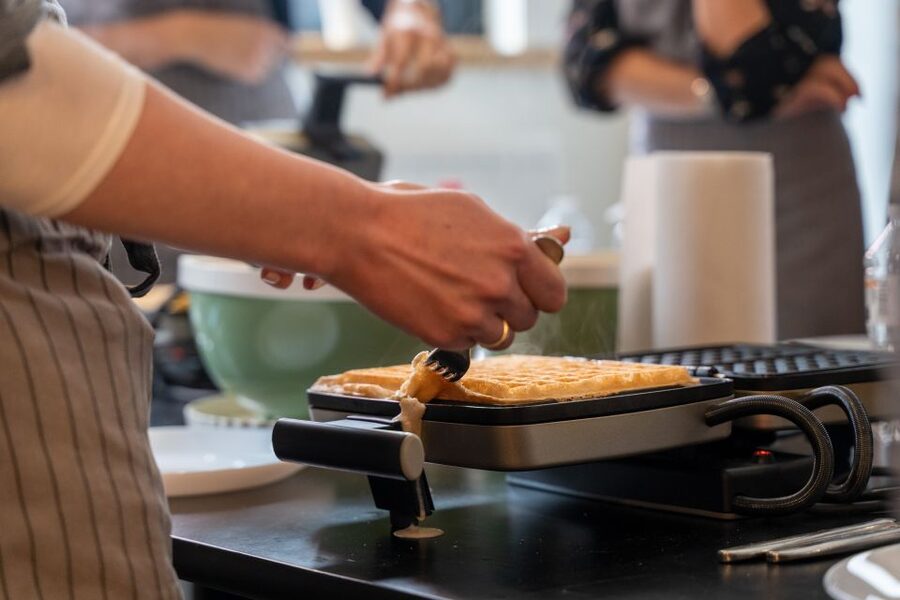 Bruges: Belgian Waffle-Making Workshop with Beer Tasting - Cooking at two-person waffle stations