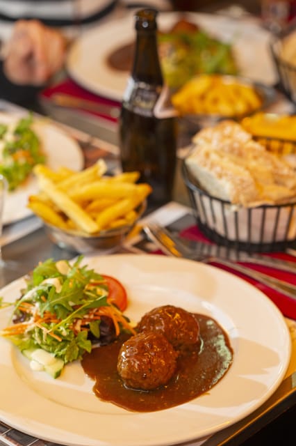 Brussels Food Tour: Main Dish, Beer, Waffle & Chocolate - Starting at Place Poelaert and entering the Marolles