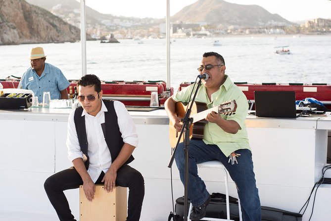 Cabo Sunset Dinner Cruise with Live Music & Open Bar on Cabo Wave - Passing Lovers Beach as the sun drops