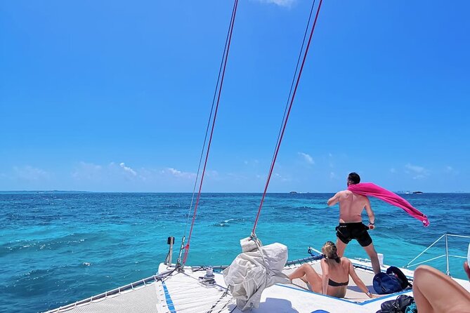 Catamaran to Isla Mujeres, Open bar, buffet, Beach Club Included - Sailing out with music and an open bar