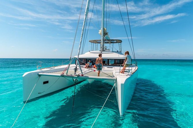 Catamaran Tour to Isla Mujeres, Open bar, Lunch, Snorkeling, Beach Club Included - Sailing across the Caribbean