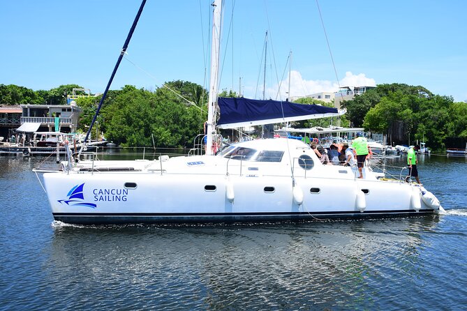 Catamaran Tour to Isla Mujeres, Open bar, Lunch, Snorkeling, Beach Club Included - Beach club, buffet, and the late lunch