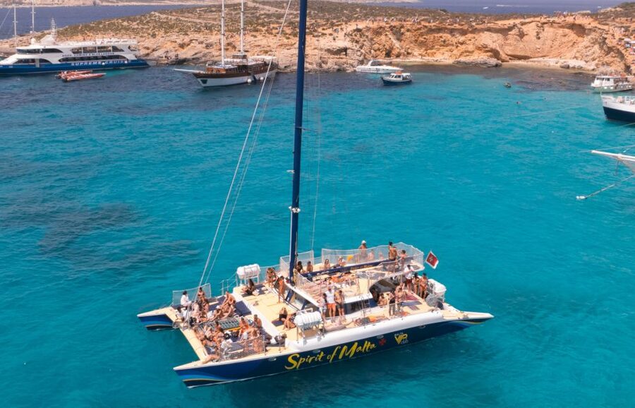 Comino: Blue Lagoon Catamaran Cruise with Lunch and Open Bar - From relaxed sailing to a floating party