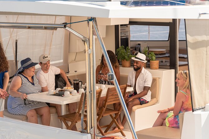 Hersonissos: Luxury Sunset Catamaran Cruise Sushi & Open Bar - Leaving Hersonissos Port with a glass of Prosecco