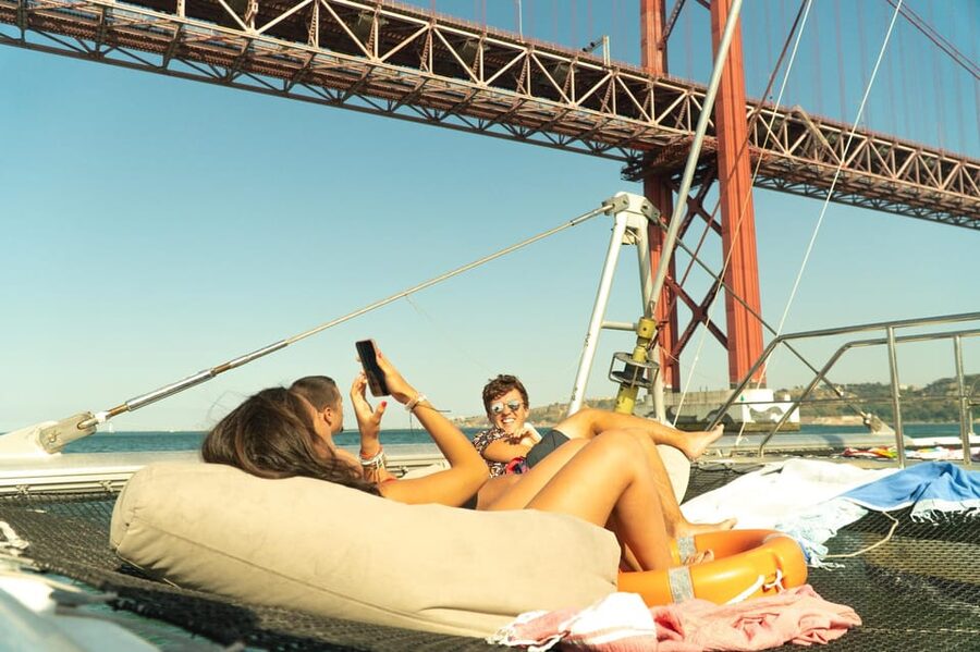 Lisbon: Catamaran Boat Party with Music, Open Bar & Dives - Leaving Alcântara for Algés