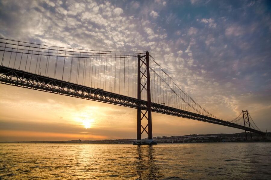 Lisbon: Disco Night Cruise with DJ and Open Bar - Passing beneath the 25 de Abril Bridge