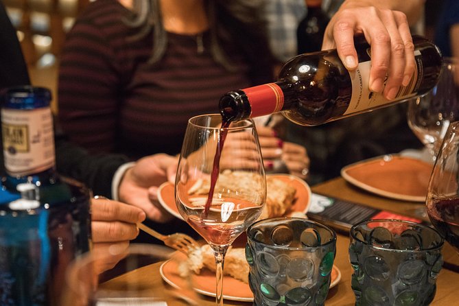 Madrid Tapas & Wine Tasting Walking Tour – Small Group Local Bars - Calle de las Huertas and the wine shop behind the bottles