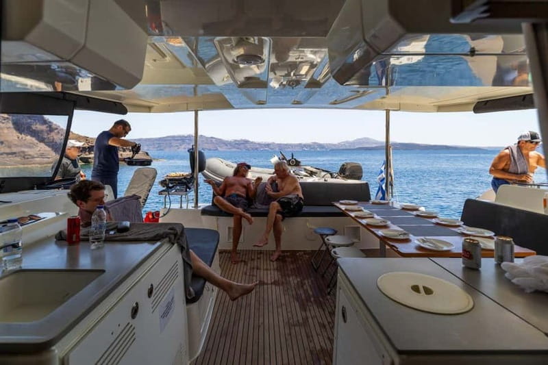 Santorini: Catamaran Cruise with Fresh Meal & Open Bar - Swimming near Black Mountain
