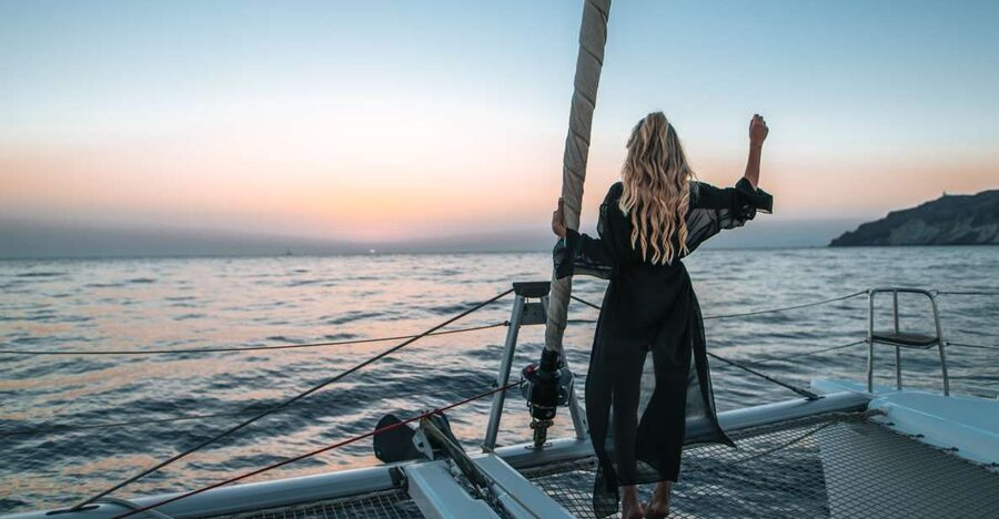 Santorini: Catamaran Cruise with Meal & Open Bar - Sunset over the caldera