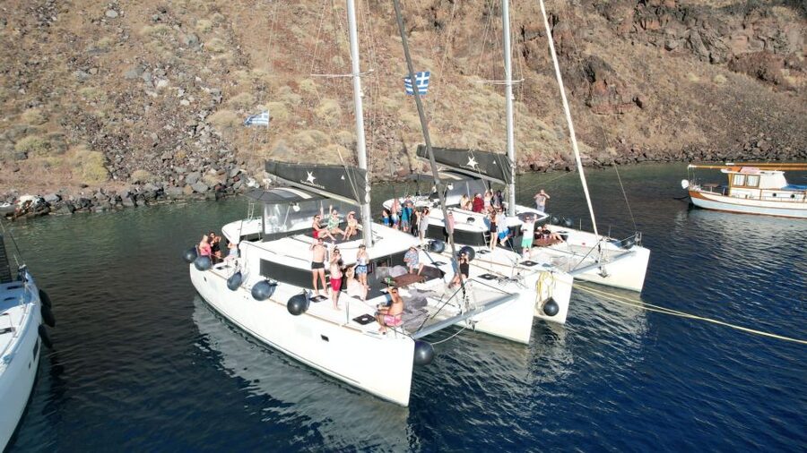 Santorini Catamaran Cruise with Swimming, Meal and Open Bar - The return past Indian Rock and Black Mountain