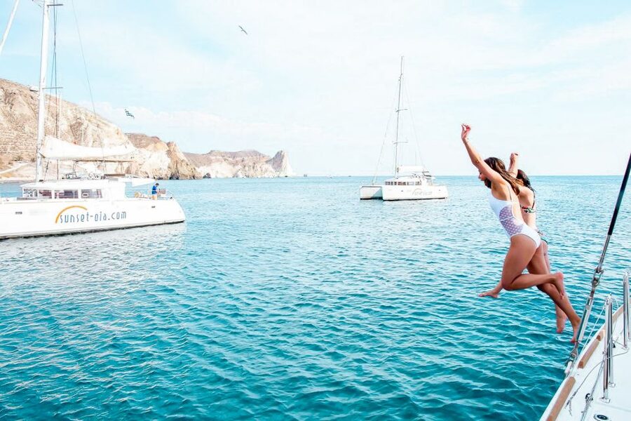 Santorini: Catamaran Tour with BBQ Meal and Unlimited Drinks - The sunset cruise below Oia
