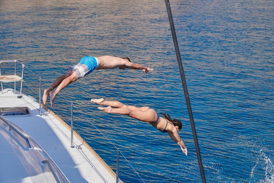 Santorini: Platinum Catamaran Cruise w/ BBQ Meal & Open Bar - Food, drinks, music, and the crew
